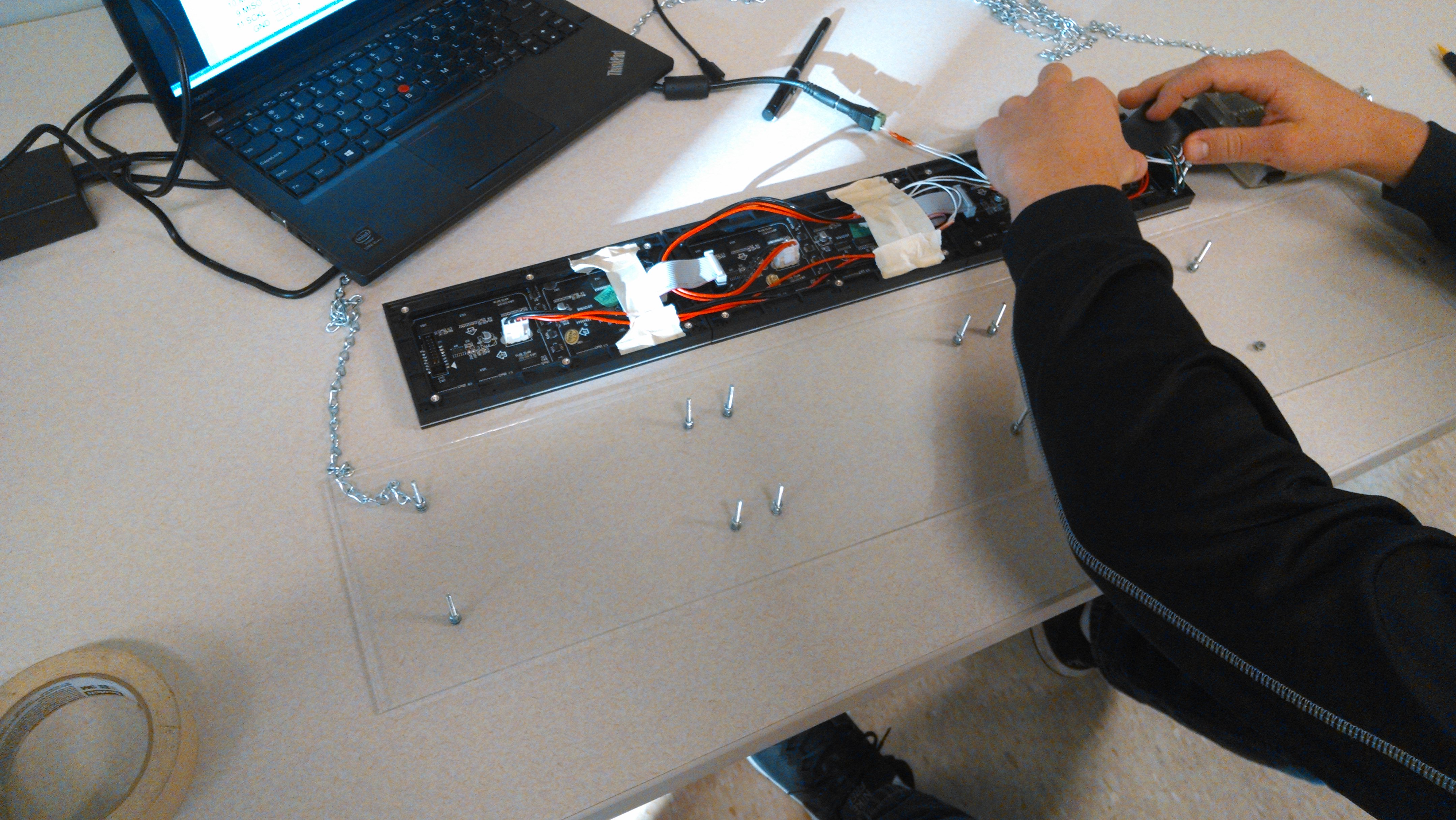 Alex wiring up the board to be installed on the plexiglass